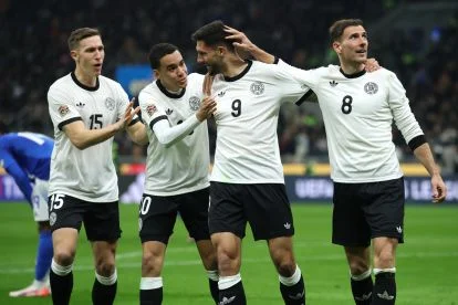 MILAN, ITALY - MARCH 20: Tim Kleindienst of Germany celebrates scoring his team's first goal with teammates Nico Schlotterbeck, Jamal Musiala and Leon Goretzka during the UEFA Nations League quarterfinal leg one match between Italy and Germany at Stadio San Siro on March 20, 2025 in Milan, Italy. (Photo by Alex Grimm/Getty Images)